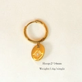Macro view of 14K gold-plated hoop earring featuring a star-engraved oval pendant - Oval Inlaid