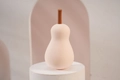 Pear-shaped pink beauty sponge blender on white pedestal for soft makeup application - Pink Pear