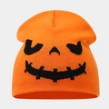 Close-up of the knitted orange beanie featuring a black woven Jack-o'-lantern pumpkin face - Style C Orange (Pumpkin Smile)