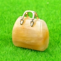 Miniature handbag pendant crafted from translucent yellow natural stone with gold handle - Topaz