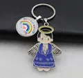 Detail view of Schulkind metal keychain with praying angel charm and rainbow pendant charm - Blue-1 Boy