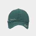 Close-up of distressed cotton fabric and white script embroidery on dark green baseball cap - Green