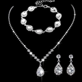 Detailed view of silver bridal jewelry set with sparkling crystals on black background - 463+796 3-Piece Stud Earrings Set / Silver