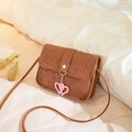 Brown mini square bag with cute cartoon embossing and pink heart-shaped pendant - Brown