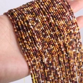 Detail of 2mm and 3mm natural agate and tiger eye stone beads in mixed earthy colors - Yellow Jasper