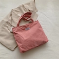 Pink corduroy tote bag with Fashion Instinct label shown on a beige blazer - Pink