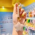Golden star-shaped keychain with sparkling clear rhinestones and matching wrist strap - White