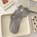 Classic grey cotton crew socks with ribbed texture and white label on cream tray - One Size / Light Gray