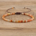 Detail of adjustable woven imperial stone bracelet with orange and red beads - No.17 Red Aventurine