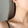 Silver safety pin earrings featuring elegant white pearls on a polished metal bar - Steel