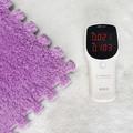 Purple plush interlocking foam floor mat shown with a multifunction air quality detector - Purple
