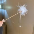 Elegant gold hair stick featuring soft white feather tufts and hanging pearl tassels - Feather Hair Stick