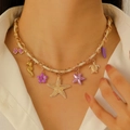 Detail of bohemian ocean necklace featuring gold starfish, seahorse and purple pendants - KC Gold Ocean (8415)