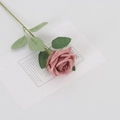 Single realistic pink-purple faux velvet rose flower with green leaves on a white card - Silk Bean Paste