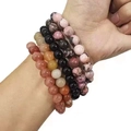 Adjustable tiger eye beaded bracelet set in pink and brown on a model wrist - Polished Stone + Pink Zebra + Strawberry Quartz + Agate Set