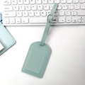 Light blue PU leather luggage tag with adjustable metal buckle on a minimalist desk set - Vertical Flip Style / Light Blue