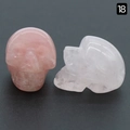 Pair of carved rose quartz skull figurines showing front and side views for decoration - Rose Quartz