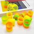 Close-up of colorful mini spring toys featuring yellow and rainbow gradient patterns - Spring Colors (Plain)