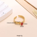 Gold plated stainless steel open ring featuring a red oval zircon and twisted band - Red