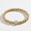 Detailed close-up of golden beaded bracelet with a sparkling crystal flower smiley face charm - Gold Smiley Flower Bracelet (0057)