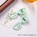 Mint green sunglasses style hair clips in a cat-eye shape for girls hair styling - Emerald Green