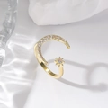 Detailed macro view of the gold moon and star ring featuring sparkling zircon gemstones - Gold Moon
