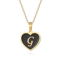 Detailed close-up of golden heart pendant featuring a black inlay and G letter design - Letter G Style
