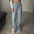 Light blue wide-leg denim jeans featuring unique cross-waist design and side leg slits - S / Light Blue