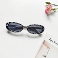 Cat eye sunglasses with black and white cow print frames and dark lenses - Small Cow Print