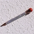 Detailed close-up of a colorful rhinestone ballpoint pen with rose gold metal accents - Red Jasper
