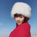 Winter faux fur Russian Cossack hat in white color worn with a red shawl outdoors - White Long Fur