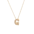 Close-up of golden necklace featuring a capital G pendant micro-paved with cubic zirconia - Letter G
