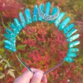 Detail of aqua blue crystals and silver filigree moon wrapped on a metal tiara headband - AB Green + White K Moon