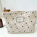 Beige corduroy makeup bag with daisy floral pattern and Time To Party woven label - Off-White Floral