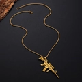 Close-up of golden rifle pendant with detailed box chain on a black textured background - Gold M4 Rifle