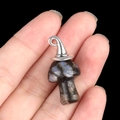Blue spotted stone mushroom pendant with silver metal cap held in hand on black background - Gun Black Cap / Blue Flash Stone