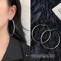 Detailed view of silver hoop earrings showing a 6cm diameter size and polished finish - 6cm / Minimalist Hoop / Silver