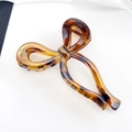 Elegant tortoiseshell resin bow hair claw clip with gradient amber finish and metal spring - Yellow Brown