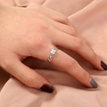 Detail of silver butterfly ring with cubic zirconia inlay on a wavy vine band - Silver/Clover Zirconia