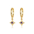 Close-up of gold hoop earrings with star charms and centered purple zircon stones - Green