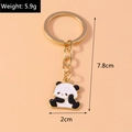 Detailed view of cute cartoon panda keychain with 7.8cm height and 5.9g weight specifications - Sitting Panda Keychain