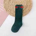 Detail of dark green cotton knee-high children socks with a large decorative bow - Dark Green (Red Green Single Bow)