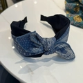 Detail of navy blue and paisley fabric headband on marble surface showing textile texture - Blue (Paisley)