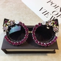 Cat eye sunglasses with pink gradient rhinestones and small white floral accents - Black Frame / Purple Red Rhinestone