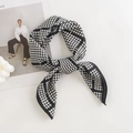 Classic black and white houndstooth silk scarf tied in a bow on a white desk - 65*65cm / Houndstooth Black