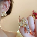 Gold flower-shaped earring and ring set with embedded clear stones on model - Style 51 S925 Silver Needle - 18K Gold Plated Zircon Flower