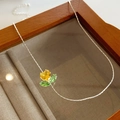 Detail of silver chain necklace with heart-shaped yellow gem and green flower pendant - Double Layer Thin Necklace - Yellow Heart Zirconia