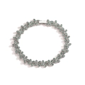 Detailed view of silver flower bracelet with green cubic zirconia clover links - Platinum Plated Green Zircon Bracelet