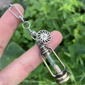 Detailed close-up of a bronze hourglass pendant with sun tag and silver chain - Style 3 (Sun Tag + Hourglass)