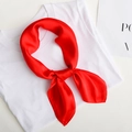 Elegant solid red silk square scarf tied in a decorative knot on white top - Red